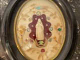 a clock with a picture of the virgin of guadalupe on it