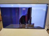 the flat screen tv is sitting on the bed in the room