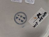 a close up of a plate with a sticker on it