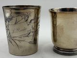 pair of antique silverplated shot glasses with etched designs