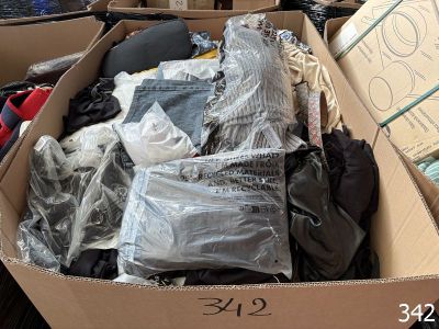a cardboard box filled with clothes and other items