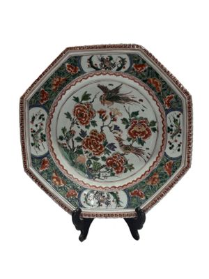 an image of a plate with a bird and flowers on it