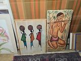 three paintings on the floor of a room with a rug