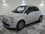 a picture of a small white car on a checkered floor