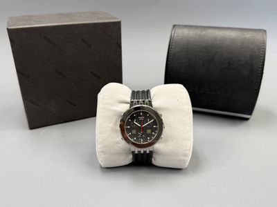 an image of a watch sitting in a box with a bow tie
