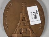 an image of a bronze medal with a picture of the eiffel tower