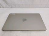 a silver apple laptop sitting on a white surface
