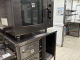 a large commercial kitchen with stainless steel appliances in it