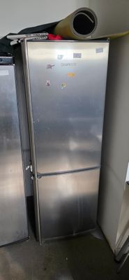 two refrigerators that are next to each other in a room