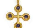 an image of a gold cross with blue stones on a white background