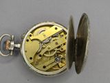 an image of a close up of a pocket watch on a table