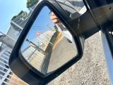 someone is taking a picture of their reflection in the rear view mirror of a car