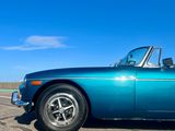 an image of a blue car parked on the side of the road