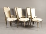 four chairs with white upholstered leather seats and a wooden frame