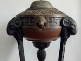 a large metal bowl with a lion head on it