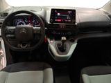 the interior of a small car with a steering wheel and dashboard