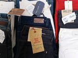 several pairs of men ' s jeans are on display in a store