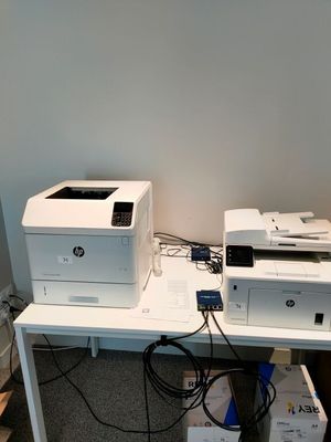 un bureau blanc sur lequel se trouvent une imprimante et une autre imprimante