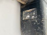 a black object on the wall next to a white wall