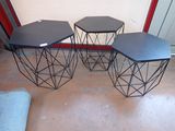 three tables that have black tops on them