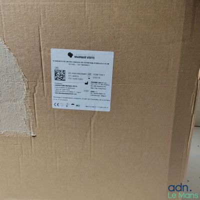 the back of a cardboard box with a sticker on it