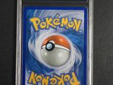 a close up of a pokemon card on a black surface