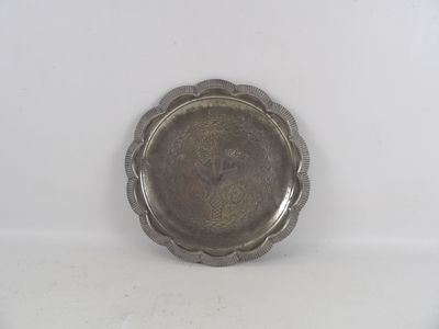 a silver plate with a flower design on it