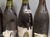 six bottles of wine are lined up on a table