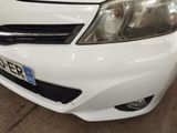 a close up of a white car parked in a garage