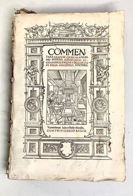 an old book sitting on top of a white table next to a white wall