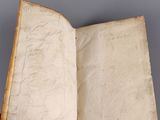 an open book sitting on top of a table on a gray surface