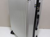 a silver suitcase sitting on a white table