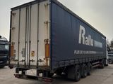 a truck that is parked in a lot with other trucks