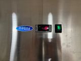 a stainless steel refrigerator with a digital clock on it