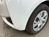 a close up of a white car parked in a parking lot