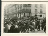 several black and white photos of people and cars on a city street