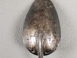 a silver spoon with a spoon handle on it