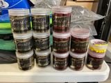 many jars of food sitting on a table next to bags of food