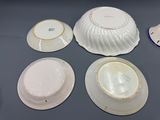 four plates and a bowl on a table
