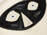 a white plate with a black and white face on it