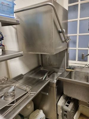 a stainless steel sink in a kitchen with a window