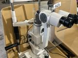 an image of a microscope sitting on top of a chair in a room
