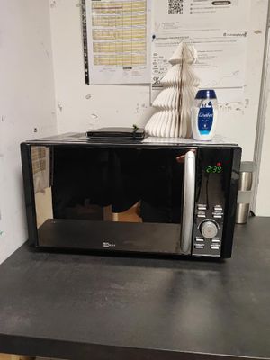 a microwave sitting on top of a table in a room