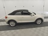 the white volkswagen suv is parked in a clean garage