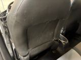 a dirty seat in the back of a car