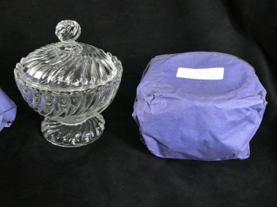 three pieces of glass are sitting on a black cloth