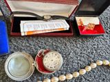 a small box with a watch and other items on the floor