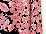 a close up of a black and pink floral dress with pink flowers