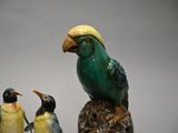 a group of birds that are sitting on a tree stump