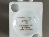 a small white plate with a rabbit head on it